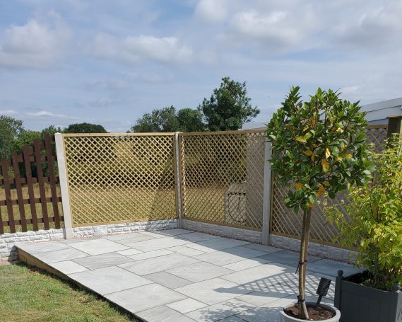 SRB Fencing @ South Normanton A fenced garden area with a paved surface and a small tree.